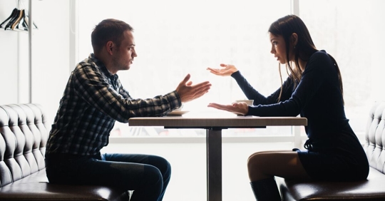 couple at a table fighting